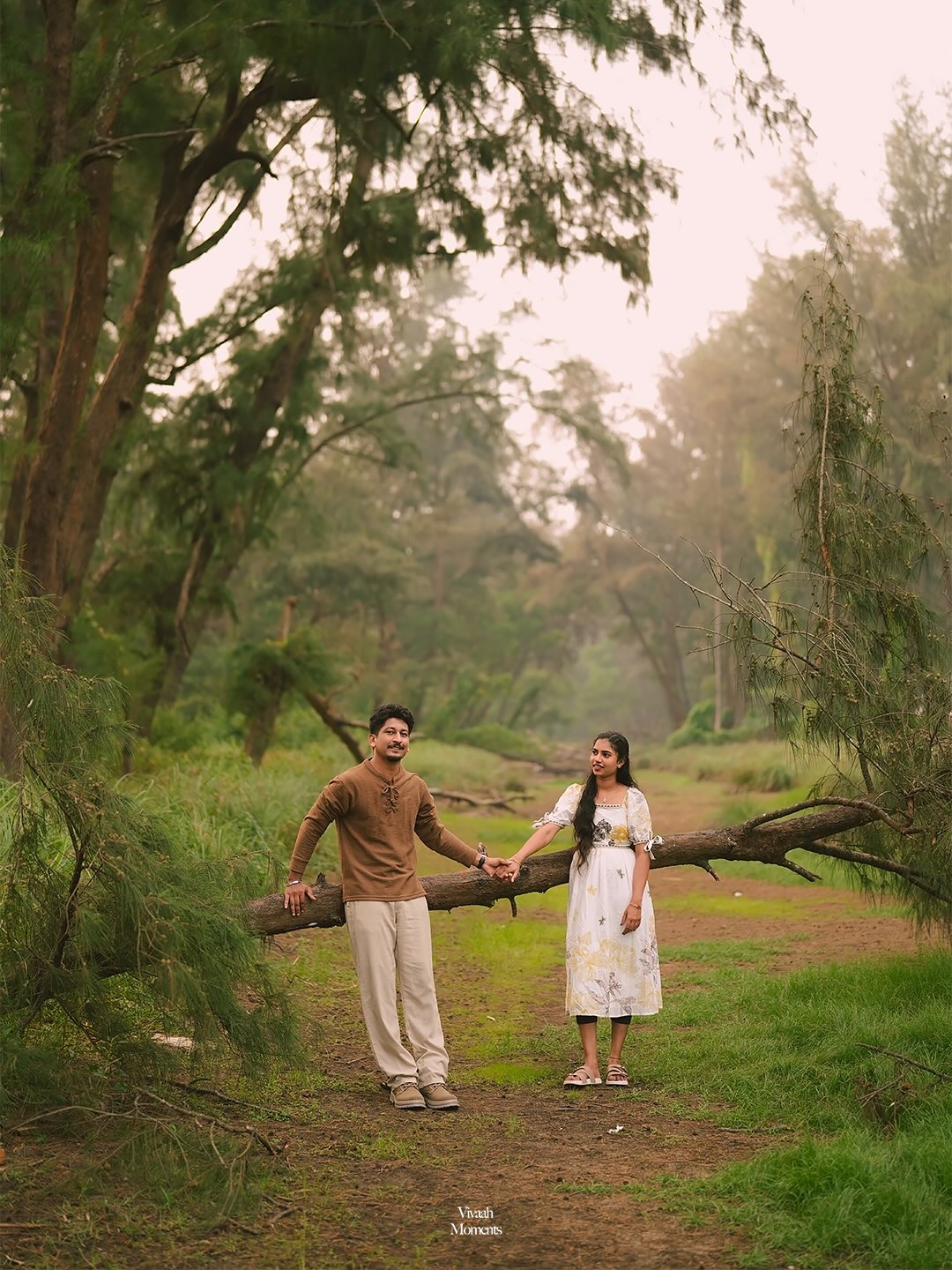 A couple holding hands in a sunlit garden