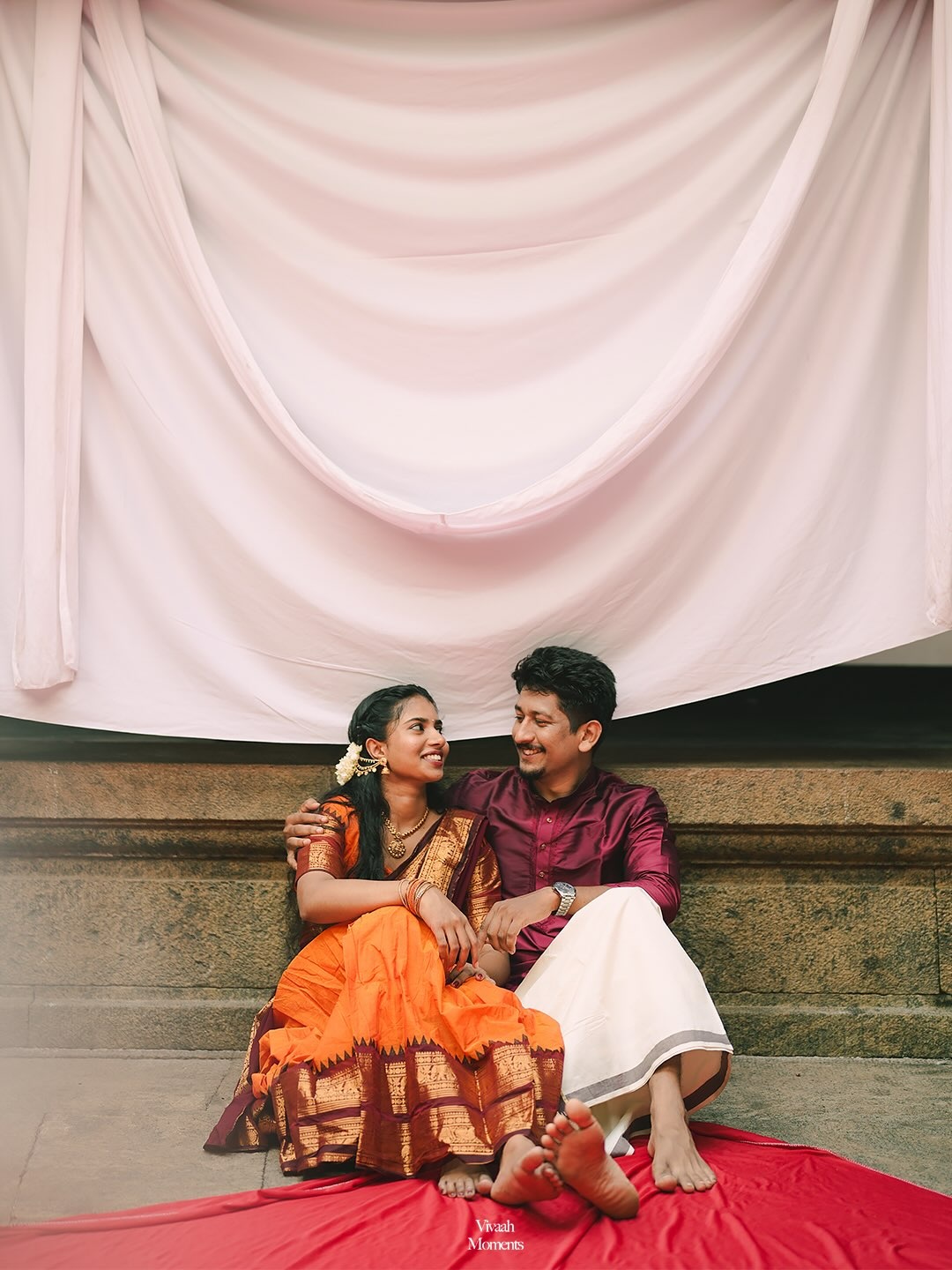 A couple in traditional attire sharing a joyful moment