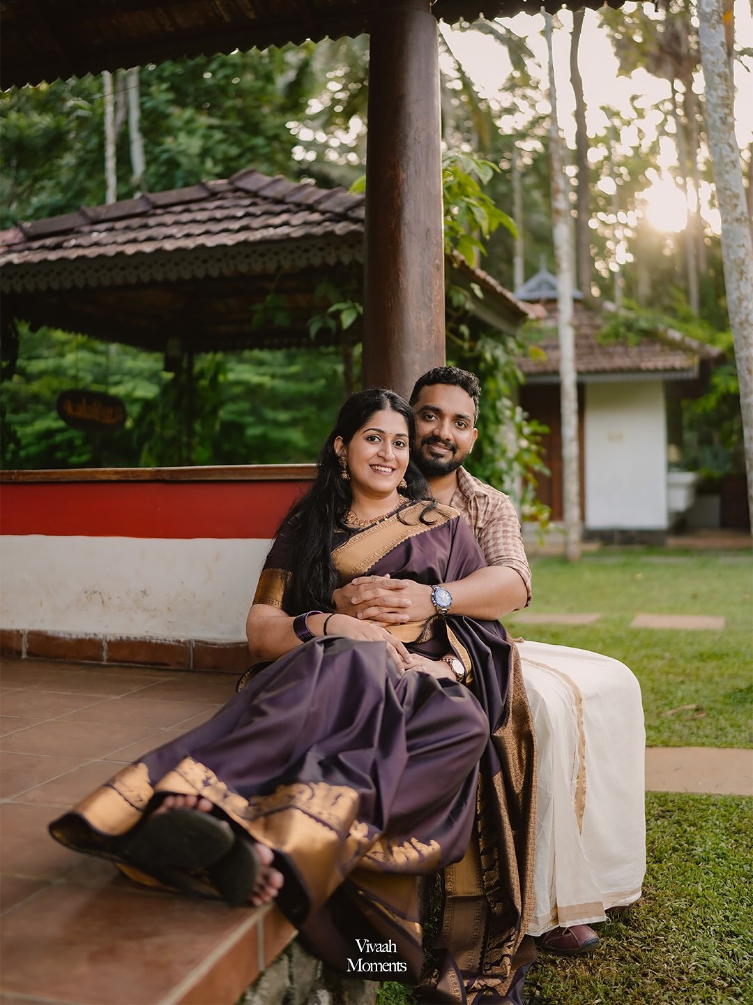 A couple seated together in traditional wedding attire